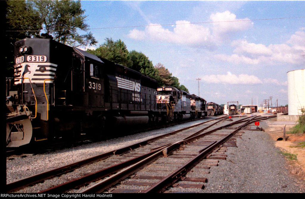 NS 3319 and a string of other locos are in Glenwood Yard